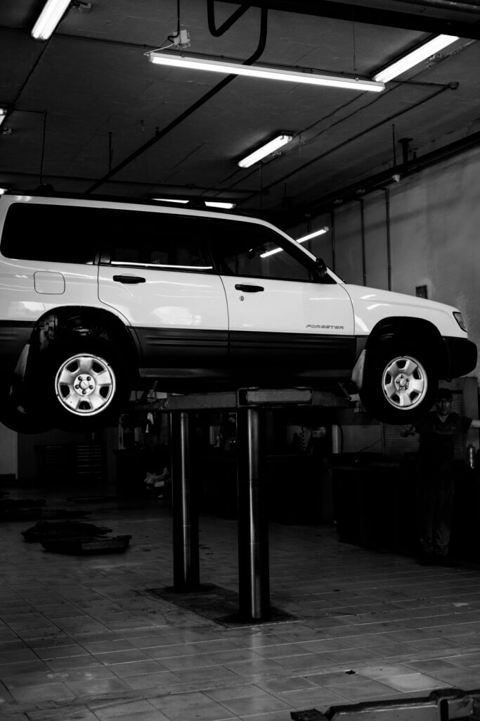Vehicle Suspension: Your Guide to a Smoother, Safer Ride 11 Vehicle on a hydraulic lift for suspension inspection at an auto repair shop in Newark, NJ.