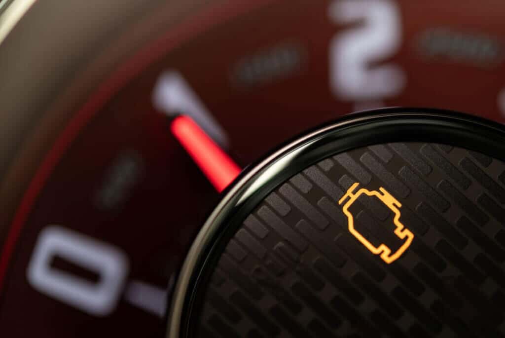 Check Engine Light: What’s Your Car Trying to Tell You? 2 A close-up image of an illuminated amber Check Engine Light on a modern car's dashboard, illustrating the topic of a blog post about what this warning means