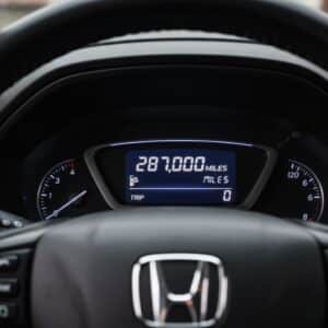Digital odometer of a Honda CR-V (likely 2012-2016 model) displaying 287,000 miles.